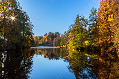 River with the sun in autumn colors reflected in the water