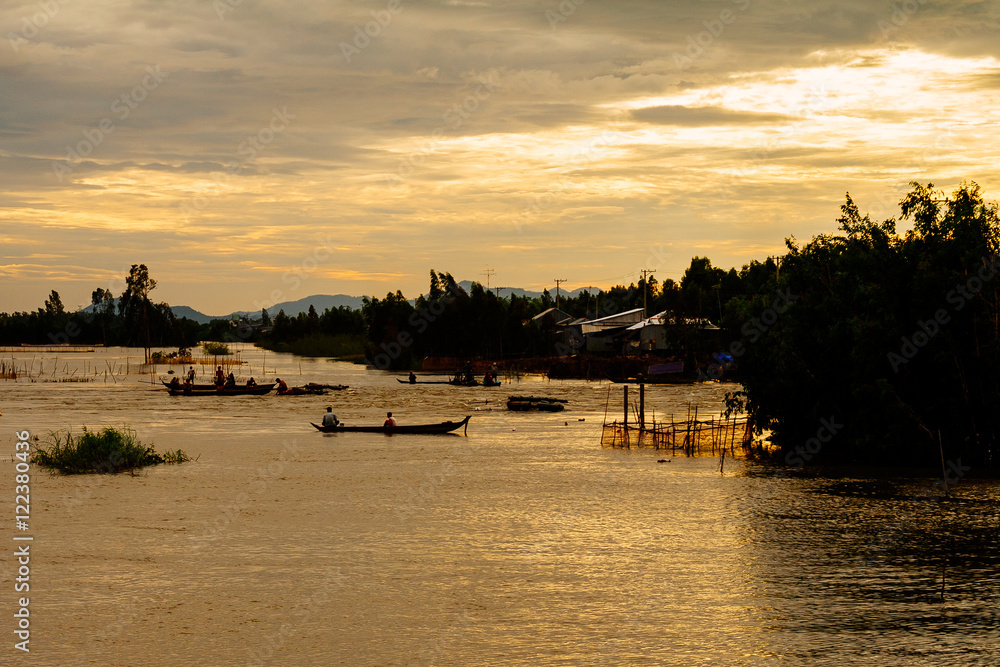 Fototapeta premium Fishing in the flood season, Chau Doc, An Giang. The annual floods (between Aug and Nov) carry nutrient-rich silt to farmland around the river and provide the moisture needed to grow fields of rice.