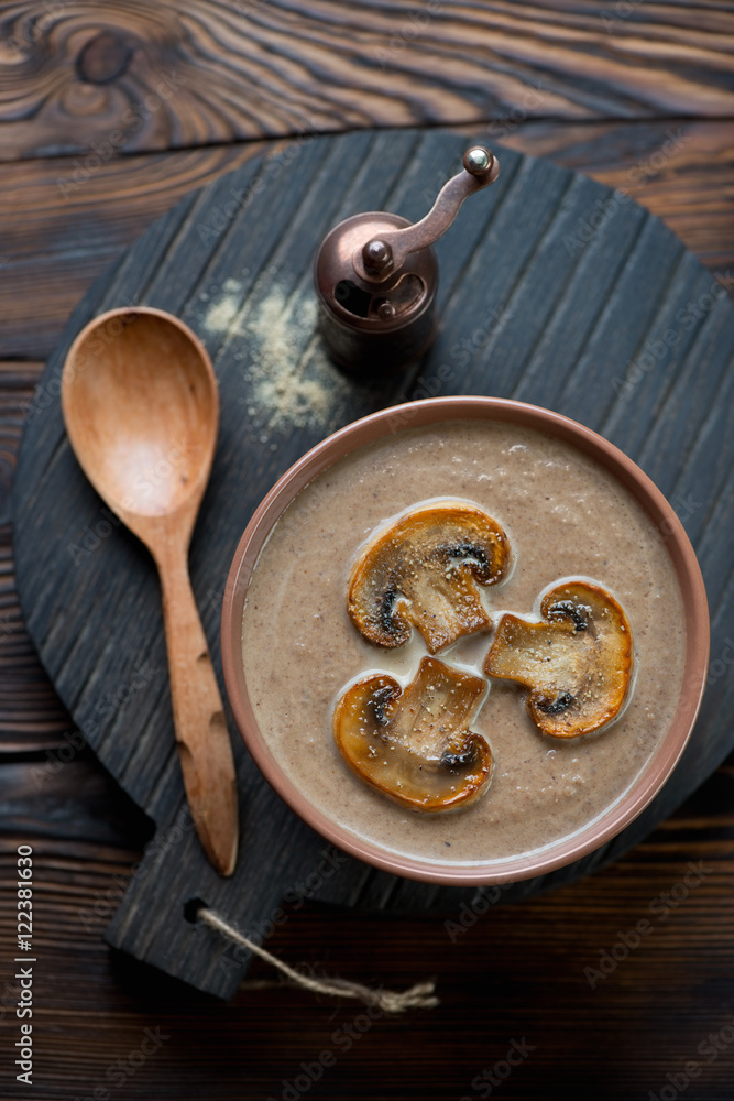 Mushroom cream-soup topped with fried champignons, above view Mushroom cream-soup topped with fried champignons, above view