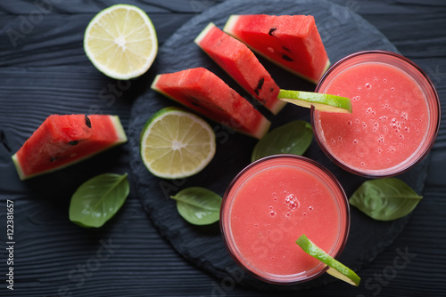 Watermelon smoothies with lime and watermelon slices, above view