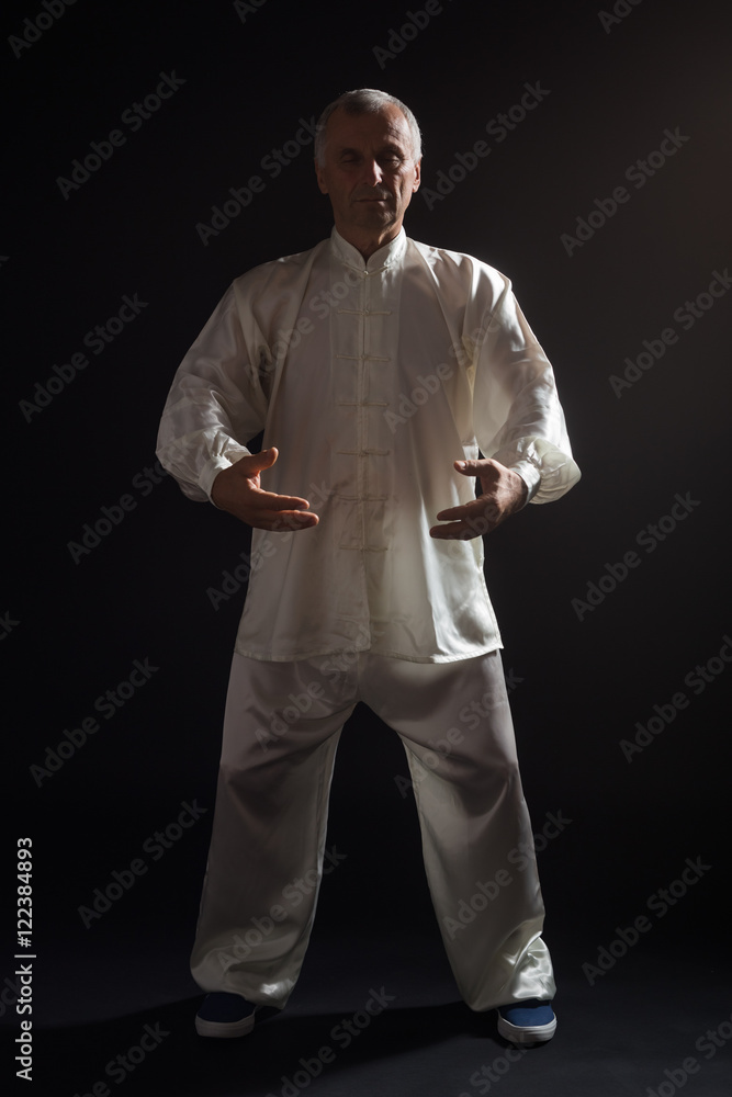 Senior man enjoys exercise Tai Chi indoor. Senior man enjoys exercise Tai Chi indoor.