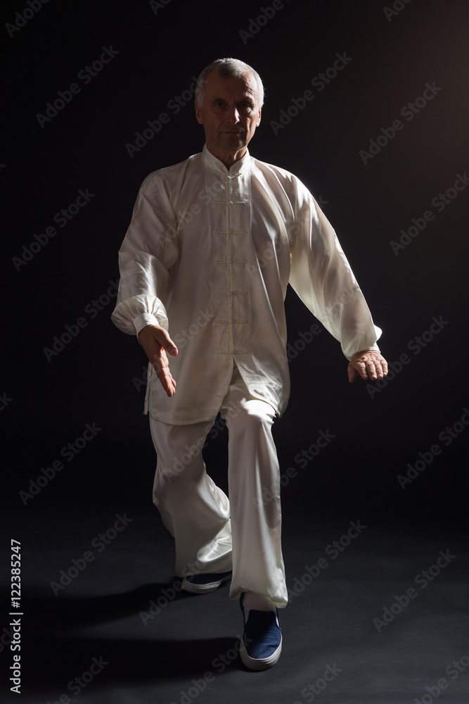 Senior man enjoys exercise Tai Chi indoor. Senior man enjoys exercise Tai Chi indoor.