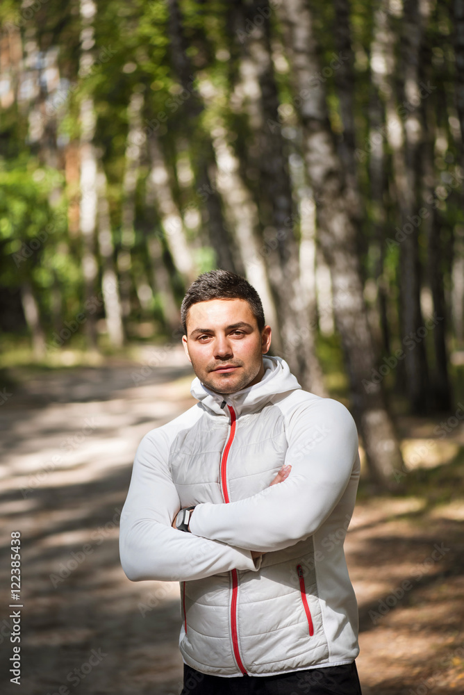 Handsome confident man jogging in a park Handsome confident man jogging in a park