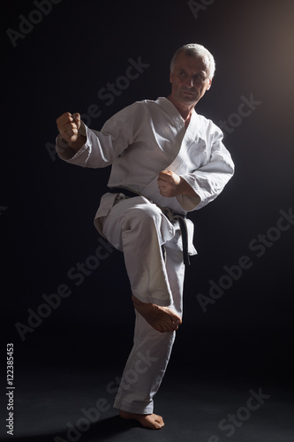 Senior man practicing karate.