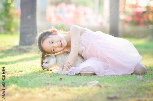 sian girl playing with siberian husky puppy