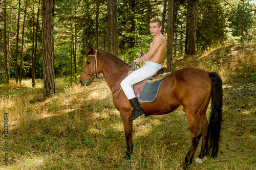 young man in the forest on horseback © Vadim Hnidash