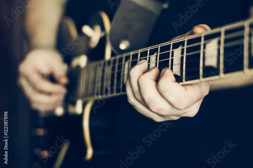 Musician playing electric guitar les paul, hands in focus