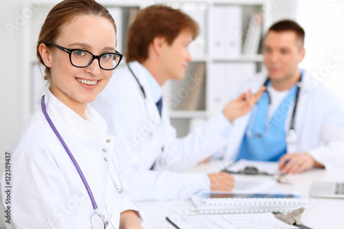 Happy doctor woman with medical staff at the hospital