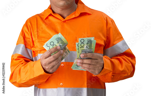 Supervisor or work man with high visibility shirt  holding and countind australian dollar as wages or reward