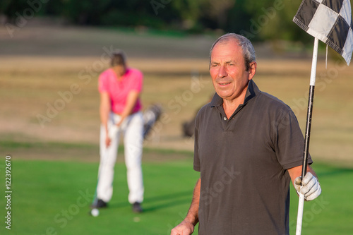 Happy Senior Couple Playing Golf