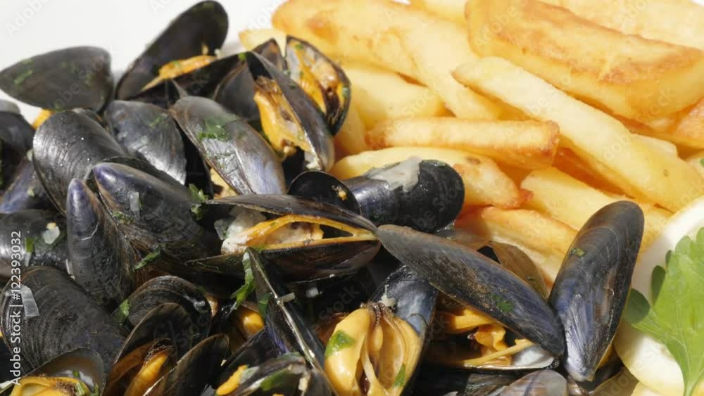 Slices of potato and Mytilus edulis tasty sea product background 4K 2160p 30fps UltraHD footage - Blue common mussel with french chips fries and lemon food 3840X2160 UHD video Slices of potato and Mytilus edulis tasty sea product background 4K 2160p 30fps UltraHD footage - Blue common mussel with french chips fries and lemon food 3840X2160 UHD video