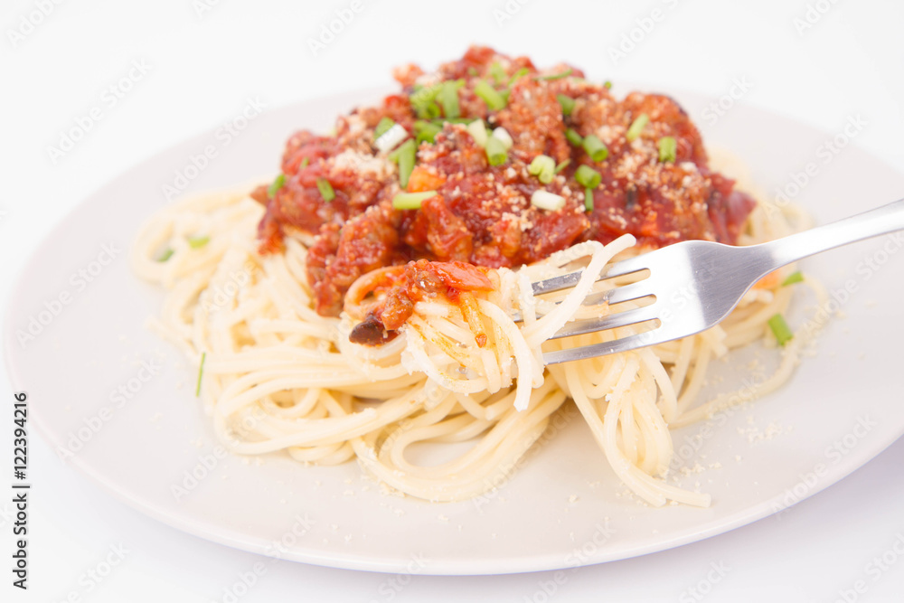 Spaghetti bolognese being eaten with a fork Spaghetti bolognese being eaten with a fork