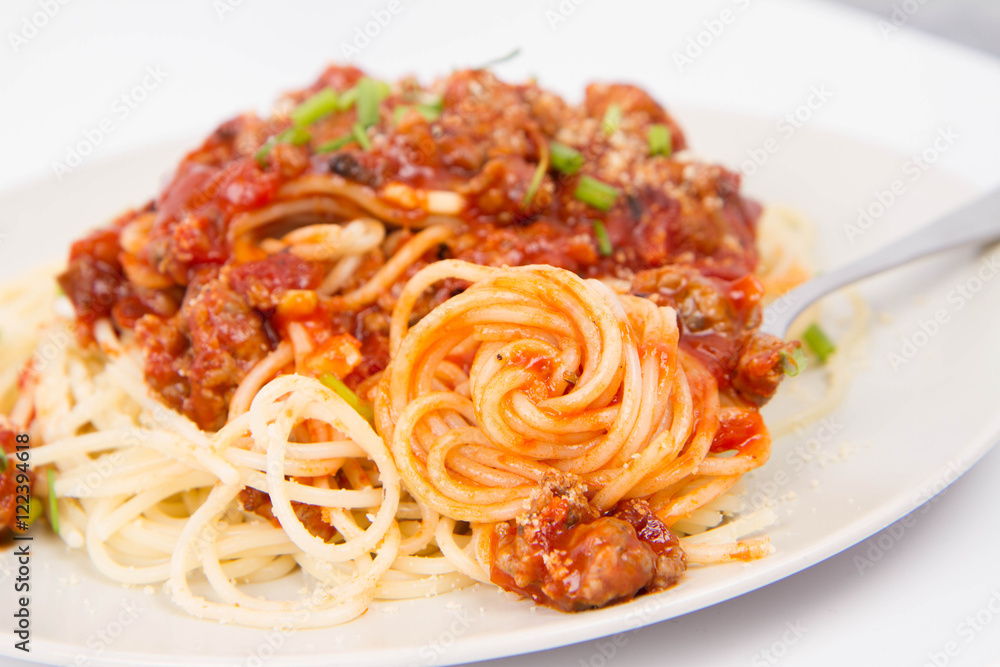 Spaghetti bolognese being eaten with a fork Spaghetti bolognese being eaten with a fork