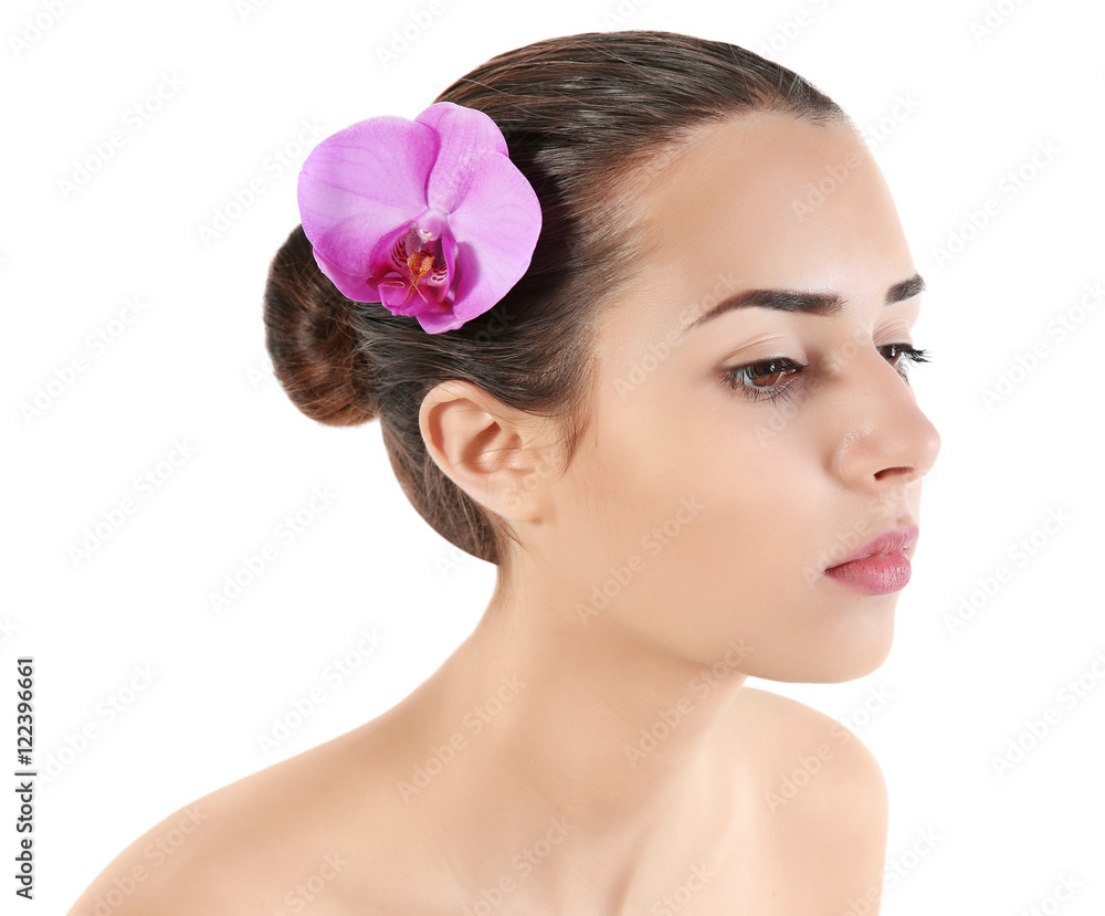 Portrait of young attractive woman with exotic flower in hair on white background Portrait of young attractive woman with exotic flower in hair on white background