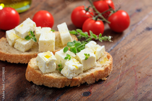 Feta cheece pieces on wooden background