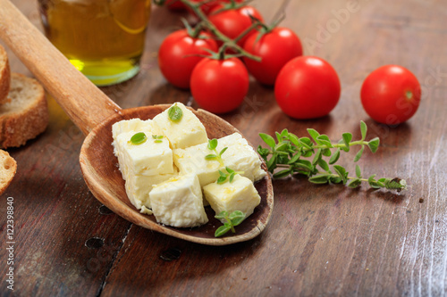 Feta cheece pieces on wooden background