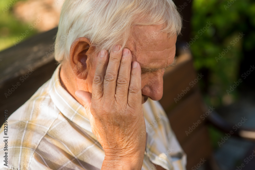 Senior man holds his head. Old person has headache. Pain is getting stronger. What a stressful day. Senior man holds his head. Old person has headache. Pain is getting stronger. What a stressful day.