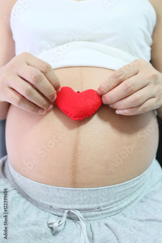 Wallpaper Mural Red heart symbol in hand a asian women pregnant. Torontodigital.ca