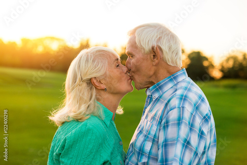 Elderly couple kissing. Woman and man outdoors. Kiss is the best present. Be with you every minute.
