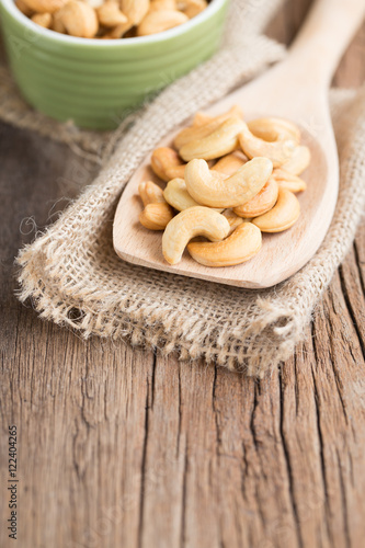 Cashew nuts on a wooden spoon