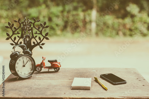 Vintage Desk Watch Phone And a notebook on the table.