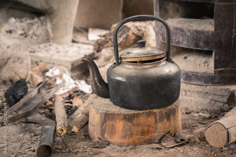Kettle on a wooden cutting board in the old kitchen,Local kitch Kettle on a wooden cutting board in the old kitchen,Local kitch