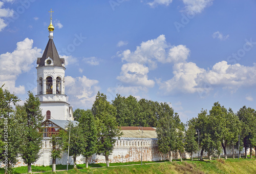 Stone tower of Vladimir Russian church under blue cloudy sky in summer