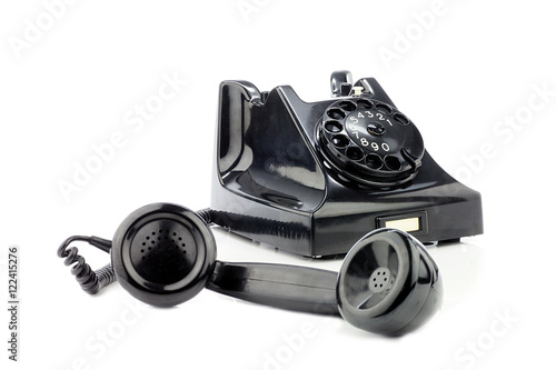 Old retro bakelite telephone. On a white background. Rear focus.