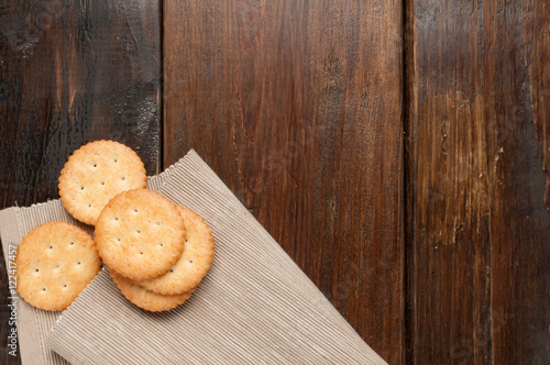 cracker stacked on brown fabric over wood table