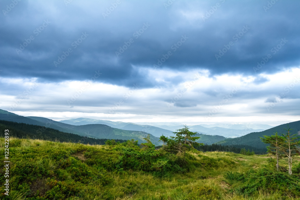 Beautiful landscape of Ukrainian Carpathian mountains and cloudy sky.