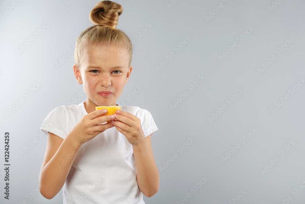 kid with lemon on grey background and copy space kid with lemon on grey background and copy space