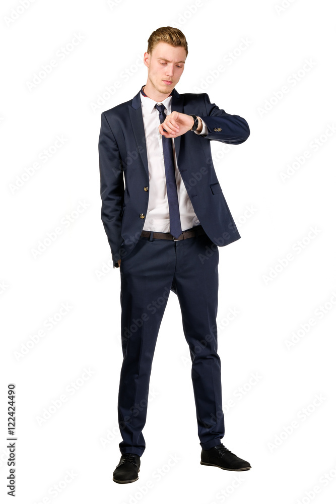 Thoughtful young businessman dressed in a suit looks at watch isolated on white Thoughtful young businessman dressed in a suit looks at watch isolated on white