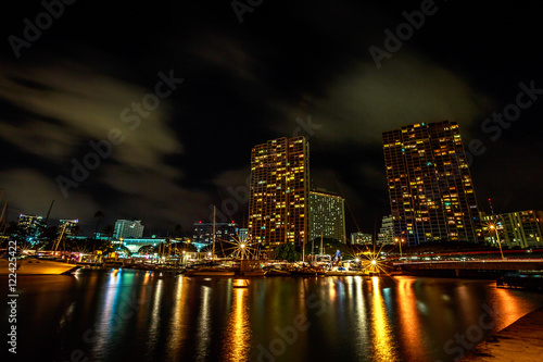 Beautiful view of Ala Wai Harbor  the largest yacht harbor of Hawaii at night. Honolulu Harbor skyline reflecting in the water. Oahu in Hawaii  United States.