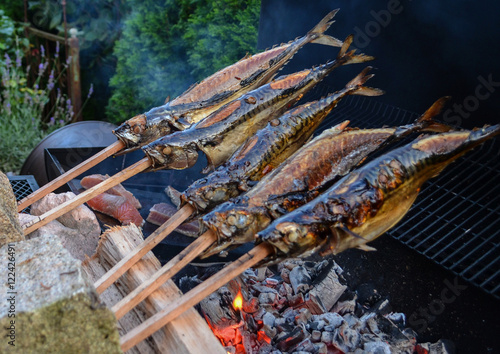 Barbecue with fish. Grilled fish on a stick