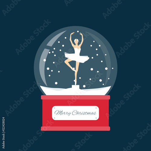 Glass ball with a ballerina dancing in the snow. New Year gift.