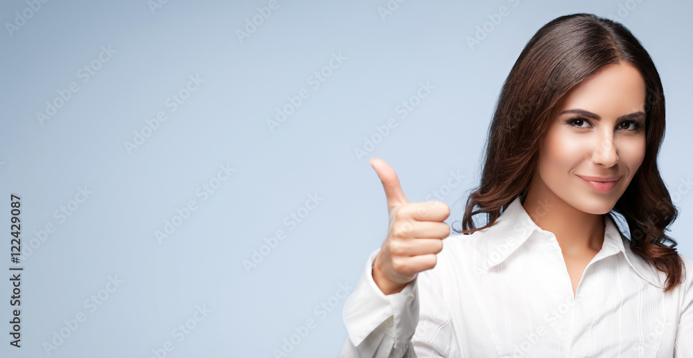 businesswoman, showing thumb up hand sign gesture , over grey businesswoman, showing thumb up hand sign gesture , over grey