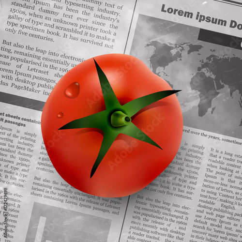 red tomato on newspaper