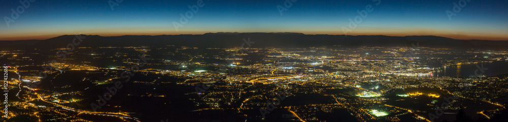 Wide aerial panoramic view of the canton of Geneva at night.