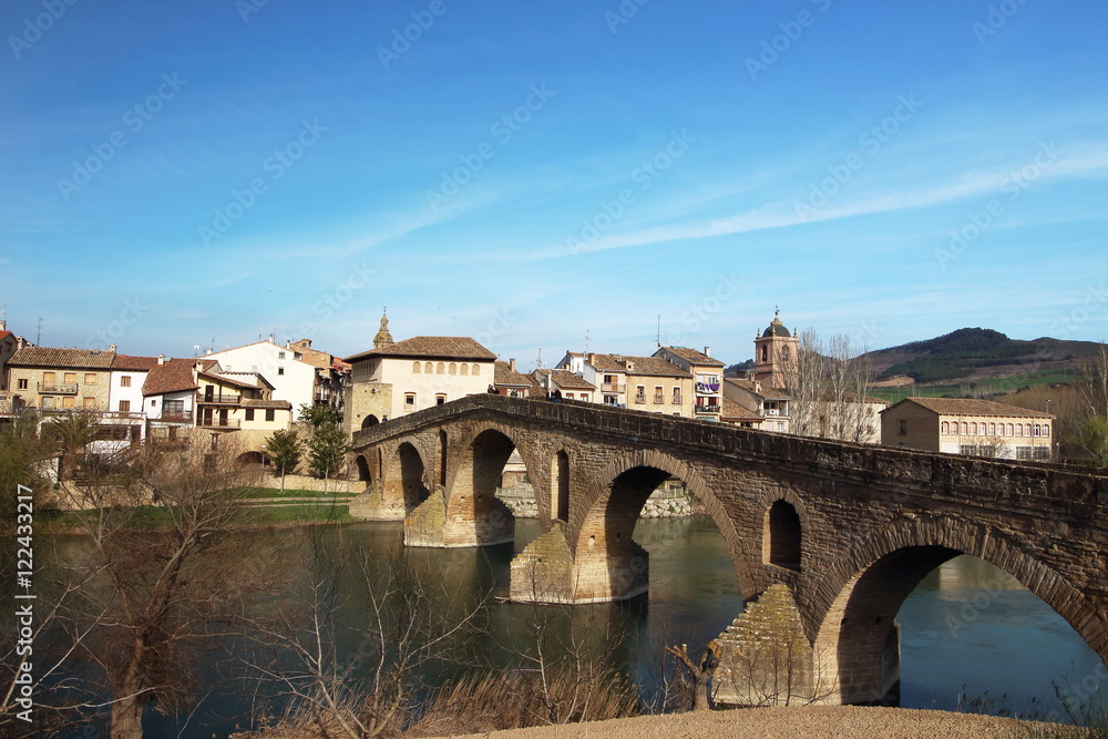 Puente de la Reina's bridge leads the way to Estella village at the beginning of the 5th stage of the Camino de Santiago, Navarra, Spain.