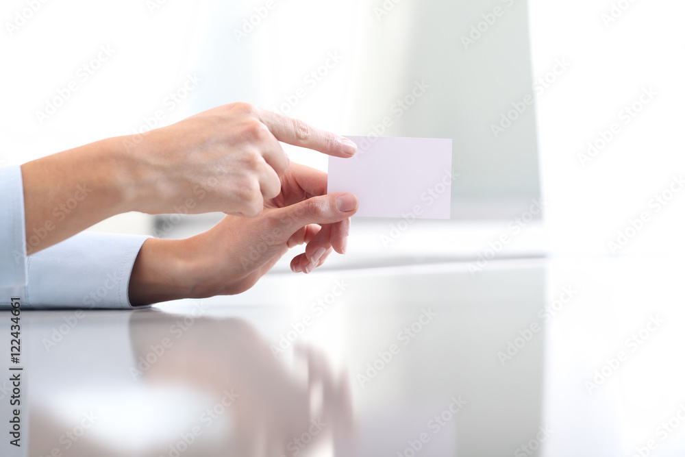 Hand showing blank business card, on desk Hand showing blank business card, on desk