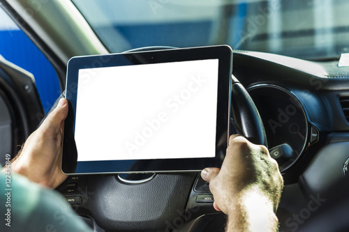 The man in the car, with the Tablet in hands photo