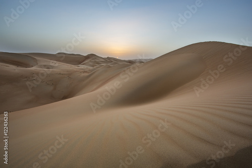 sunset over sand dunes of Empty Quarter desert