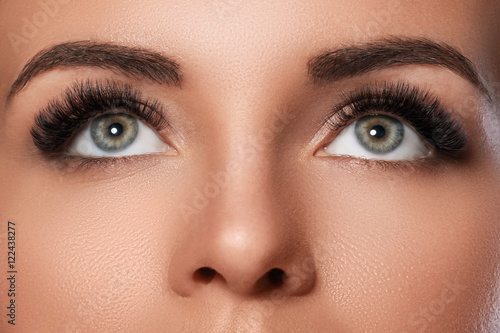 Female face with beautiful eyebrows and artificial eyelashes photo