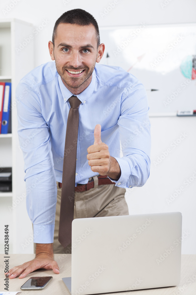 Fototapeta premium Happy businessman working in his office on the laptop