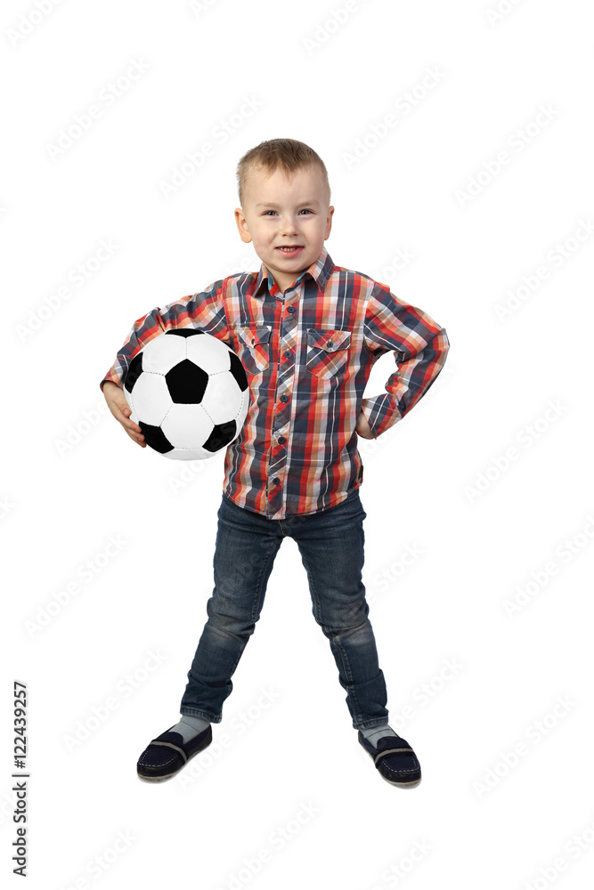 Little boy stands with soccer ball under his arm full height isolated on white background