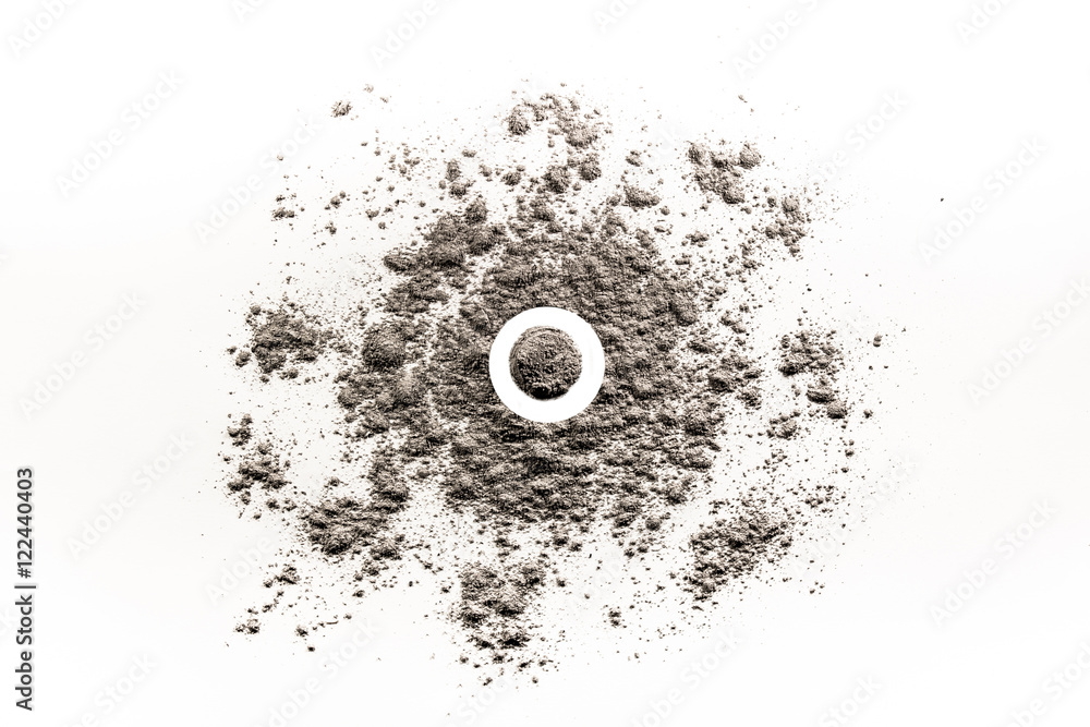 Circle shape in a pile of scattered ash, sand, dust