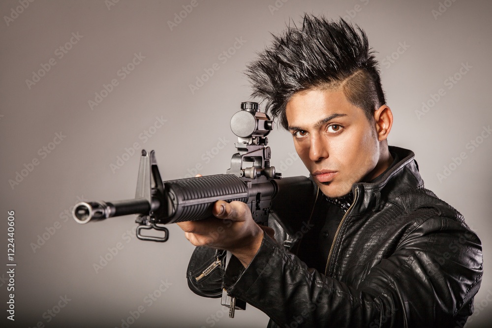 Man in black suit holding gun. Man in black suit holding gun.