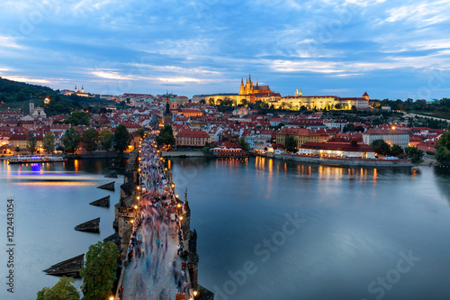 Panorama of Prague with red roofs and Charles bridge from above at dusk, Czech Republic, Europe
