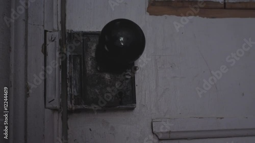 Something trying to open an old door