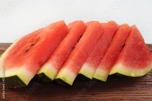 Slices of red watermelon on wooden board